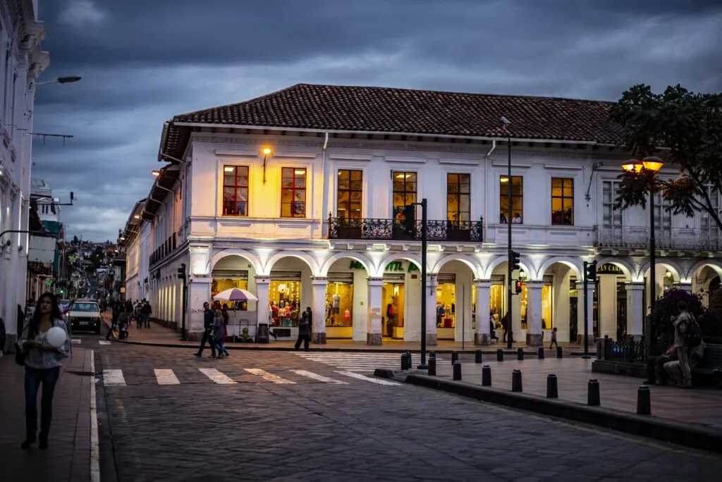 A large white building on the edge of Parque Calderon in Cuenca, Ecuador.