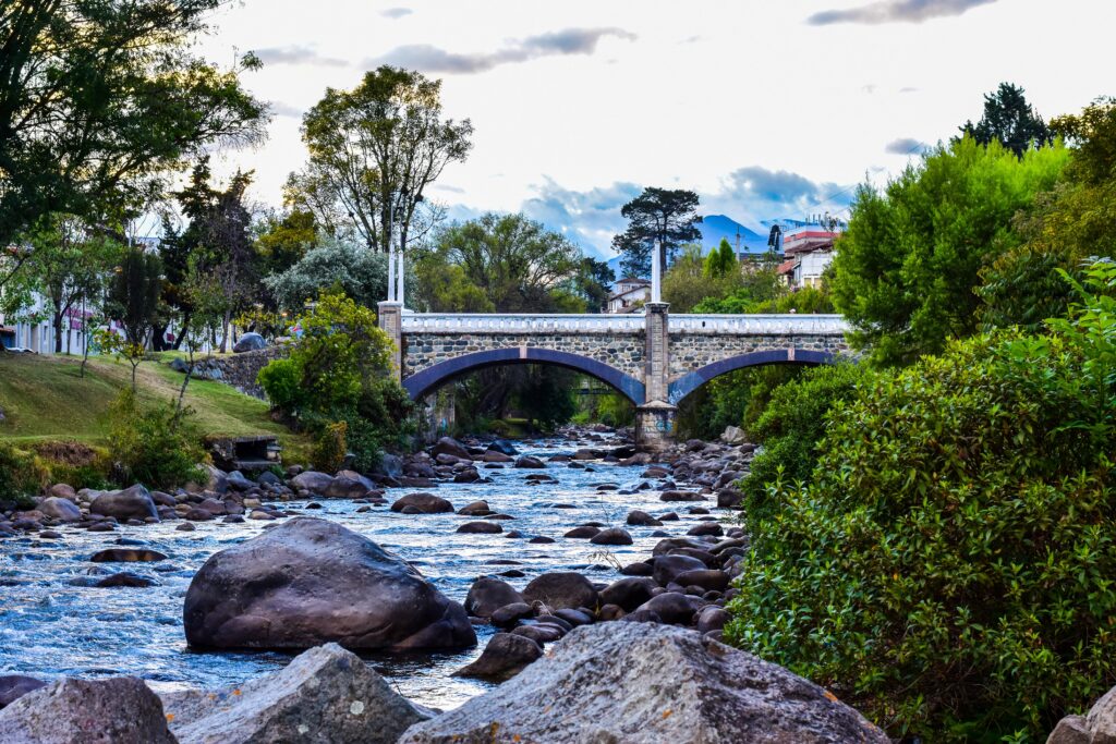 The Tomebamba River flows under a bridge in Cuenca, Ecuador.