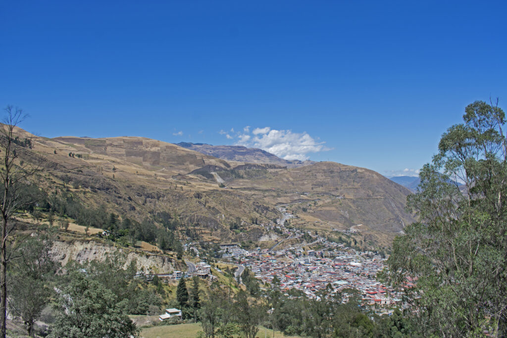 The town of Alausí, Ecuador, seen from the mountains above. It sits in a large valley