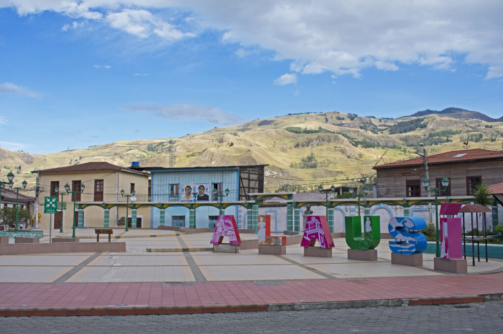 The main square of Alausi, with a sign of the village’s name and colonial buildings