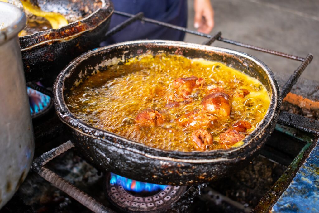 A large vat of stew boils on a stall set up by the side of a road in Manabí, Ecuador. Wheely Tyred Best Food on the Ecuadorian Coast