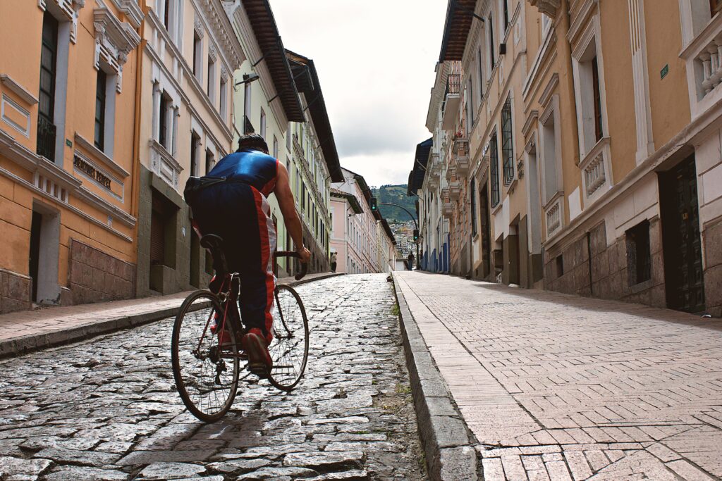 A cyclists rides through the cobbled streets of Quito, Ecuador.