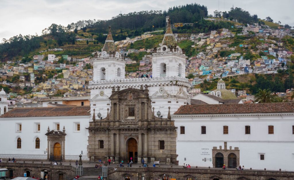The Basilica and Convent of San Francisco with a huge hill covered in houses sits in the centre of Quito, Ecuador