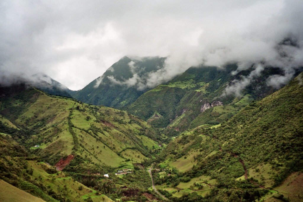 Clouds fill a deep, steep green valley in Mindo, Ecuador