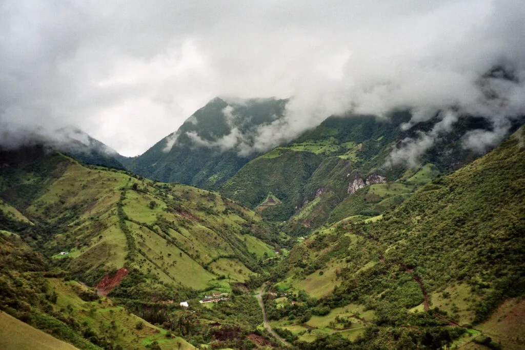 Clouds fill a deep, steep green valley in Mindo, Ecuador
