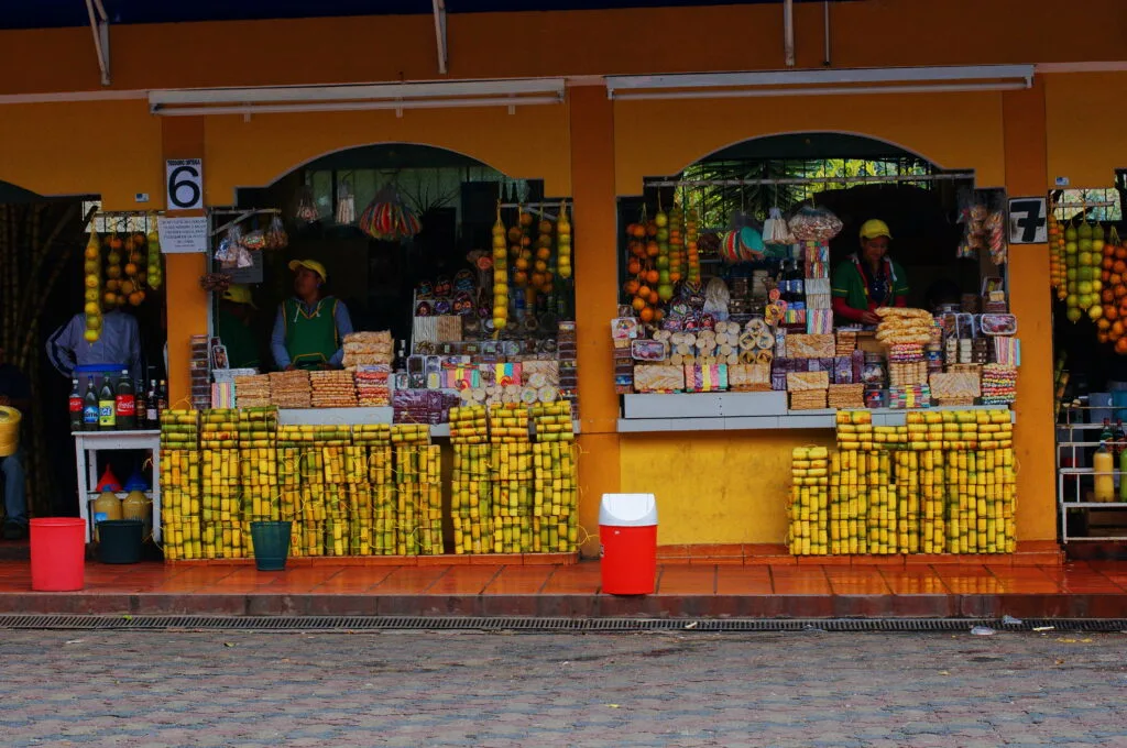 Sugar cane and melcocha vendors in Baños, Ecuador