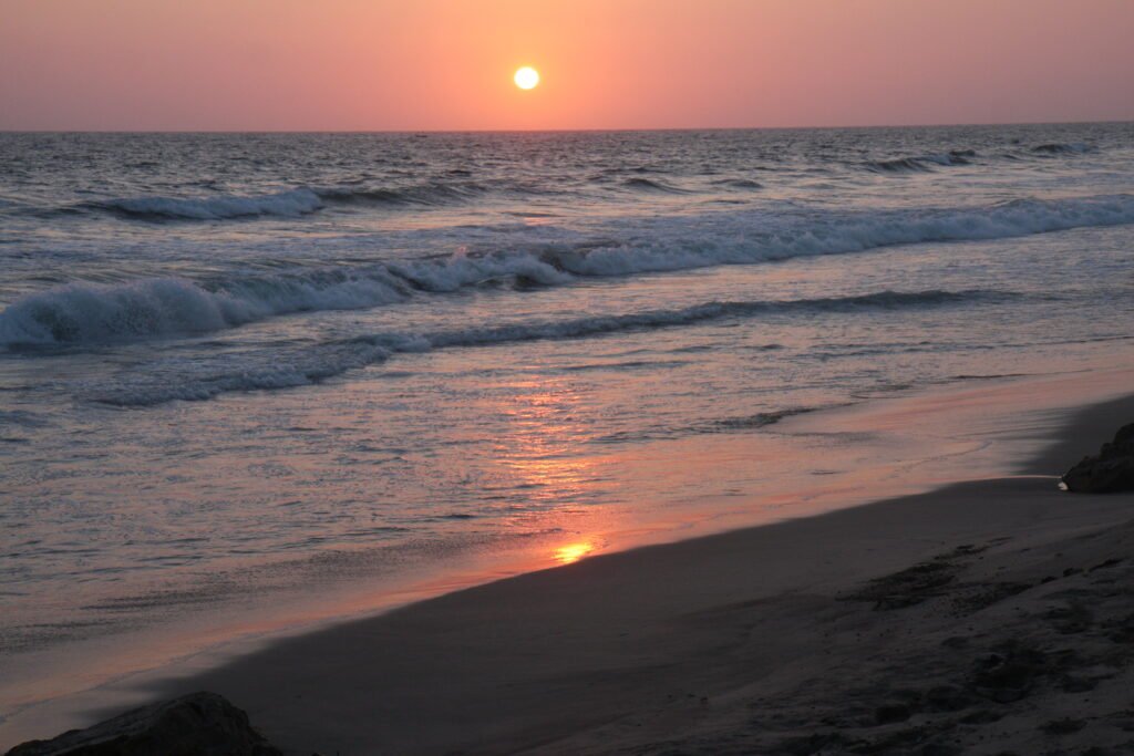 The sunset is reflected in the waves of a beach on the Santa Elena coastline, Ecuador.
