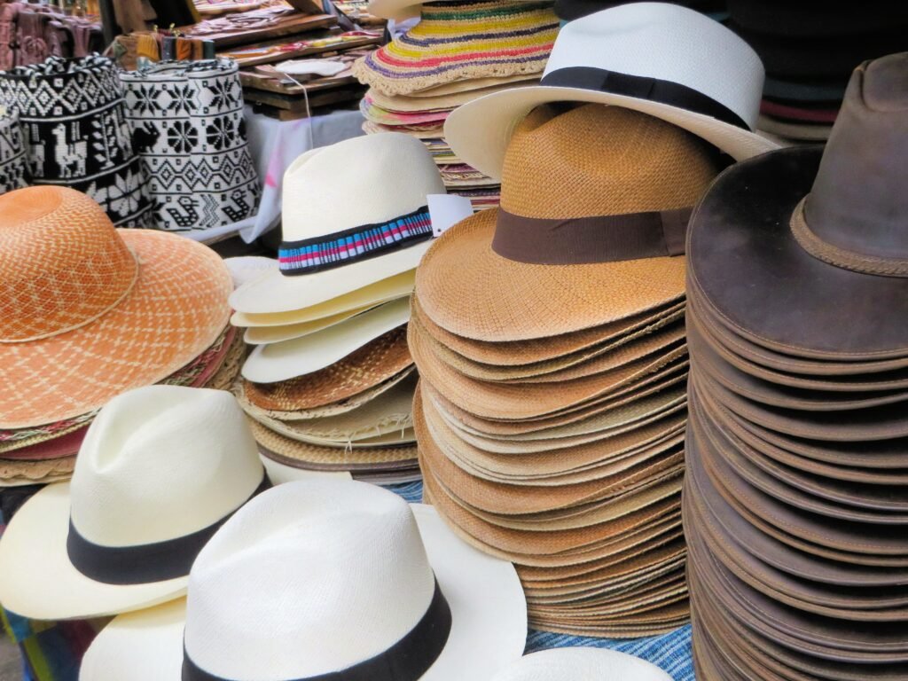 Racks of indigenous hats on sale in a plaza market in Otavalo, Ecuador.