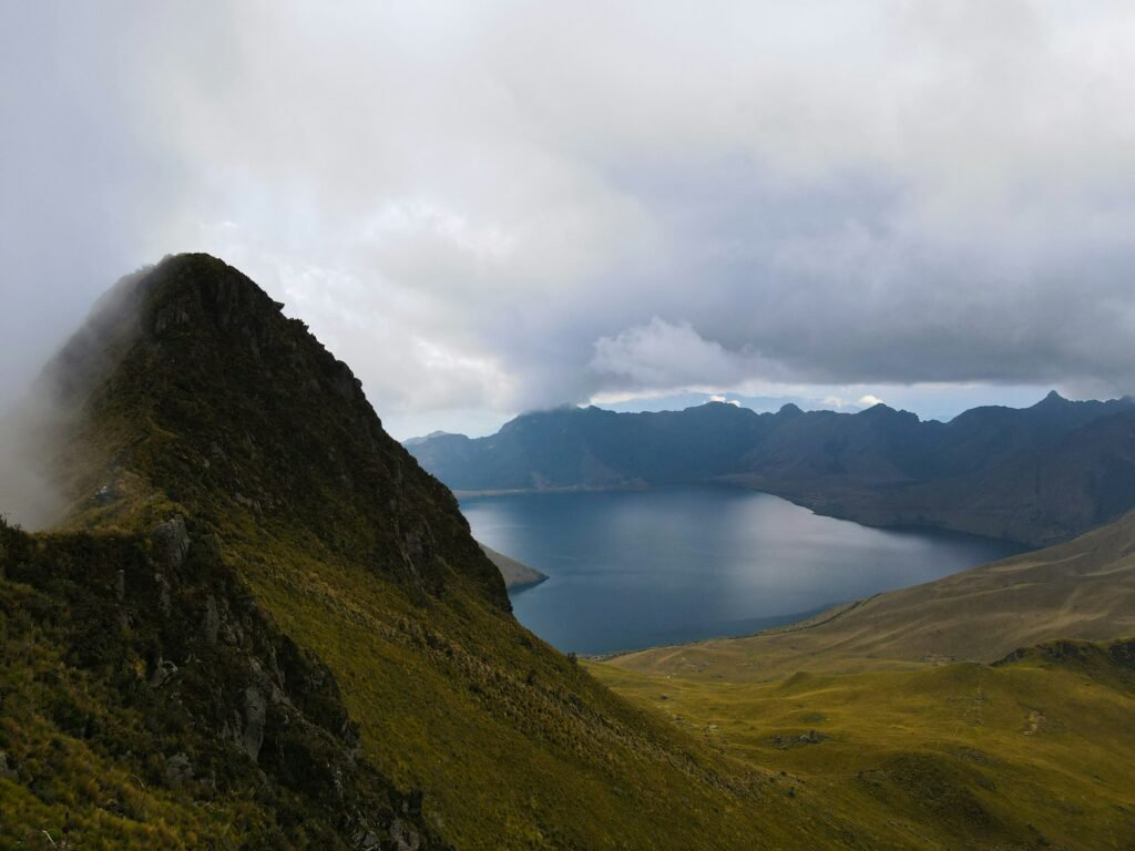 The collapsed crater of Fuya Fuya volcano holds a lake under low clouds, near Otavalo, Ecuador.