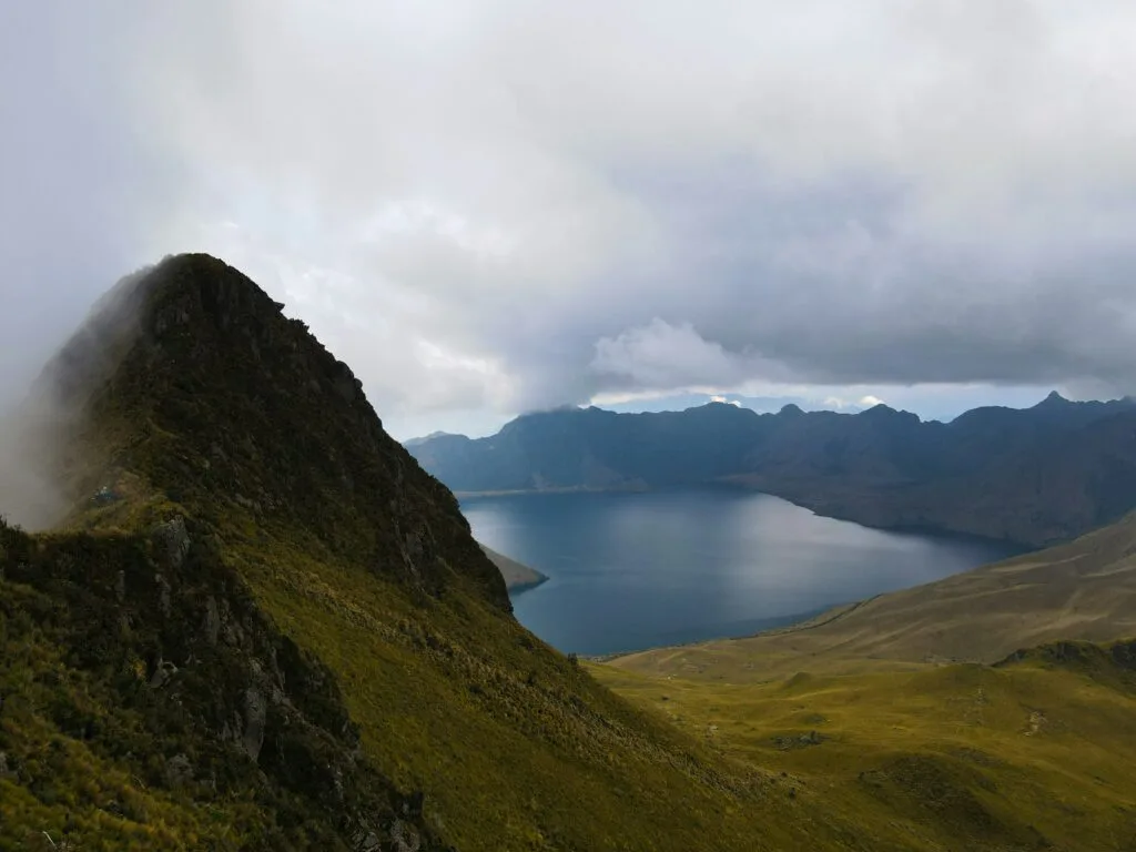 The collapsed crater of Fuya Fuya volcano holds a lake under low clouds, near Otavalo, Ecuador.