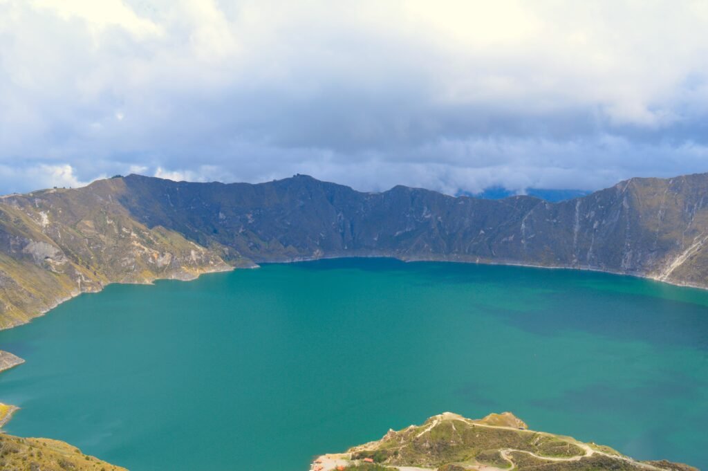 The edge of the rim of the caldera above a bright blue lake at Quilotoa, Ecuador.