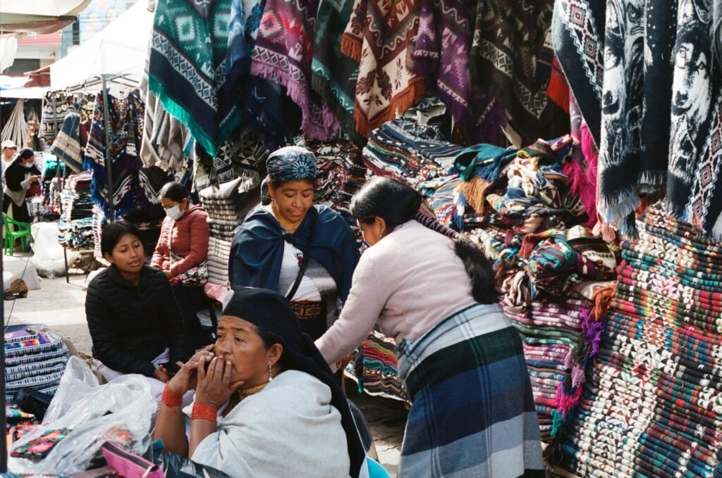 Indigenous women shop in Plaza de Ponchos in Otavalo, Ecuador.