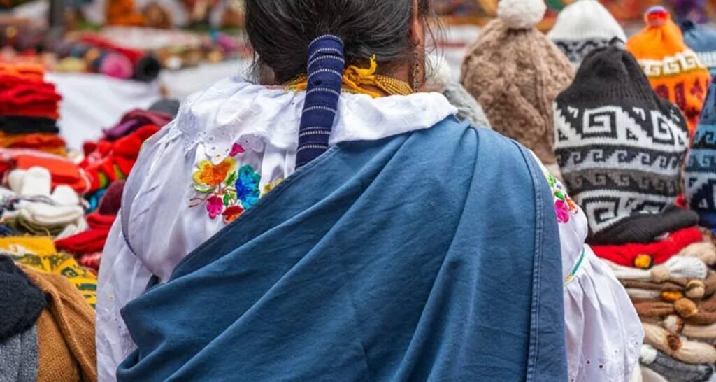 An indigenous woman looks at a market stall in Otavalo. Wheely Tyred Best Ecuador multi-day tours
