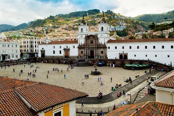 The Plaza of San Francisco with a huge white church rising out of it in Quito, Ecuador