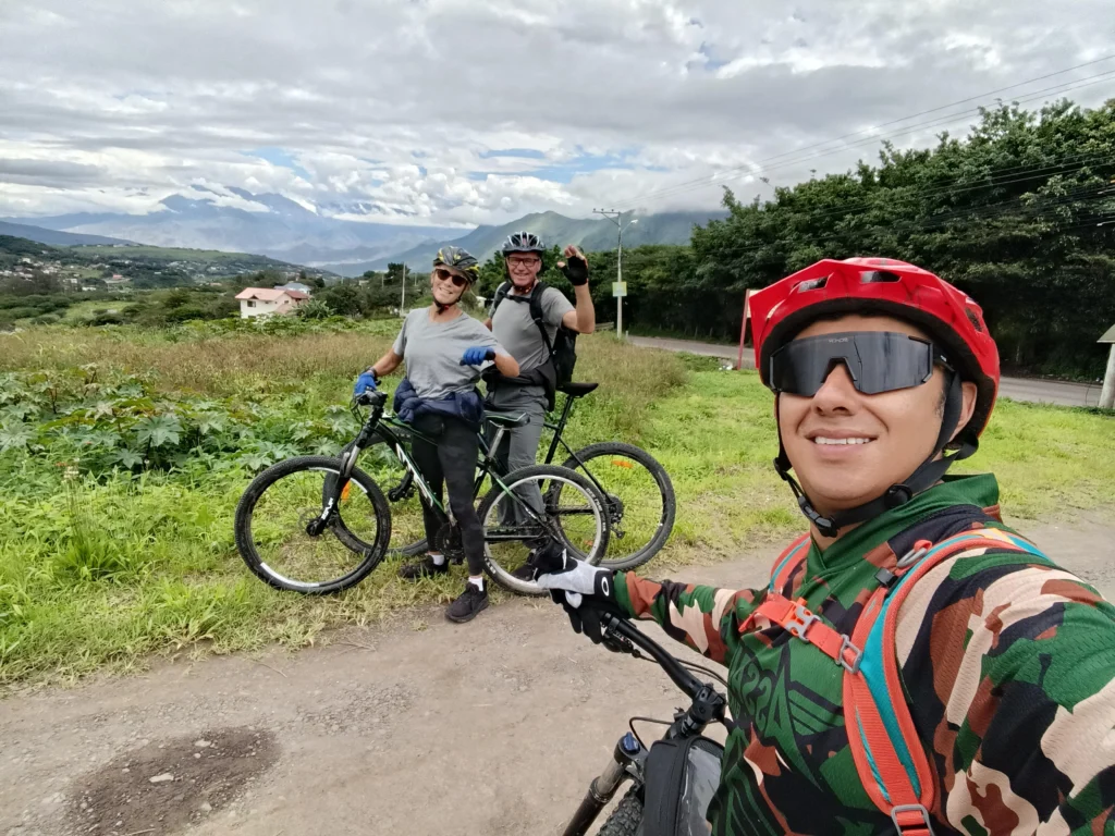 Three cyclists pose for a picture in the countryside near Cuenca, Ecuador