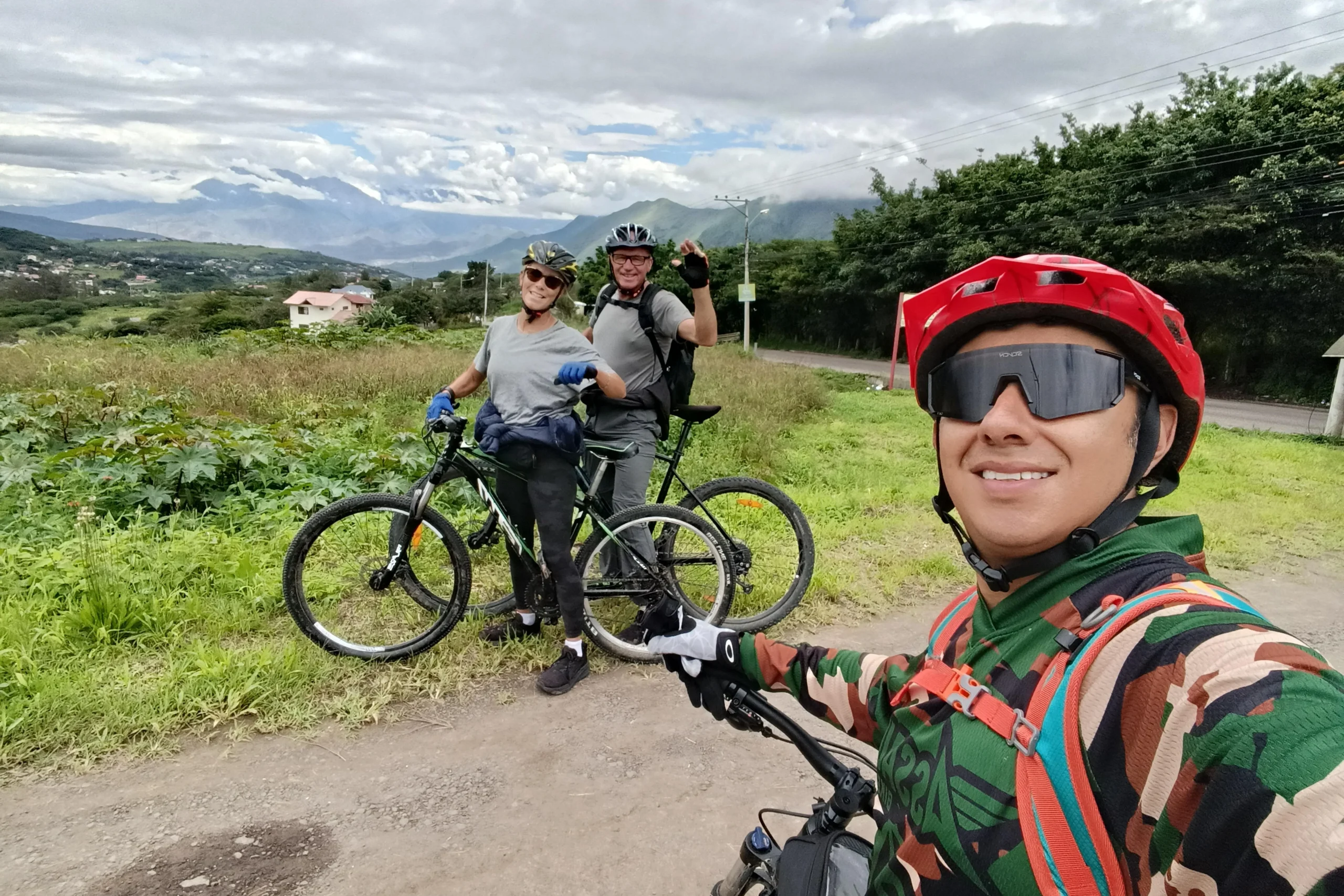 Three cyclists pose for a picture in the countryside near Cuenca, Ecuador