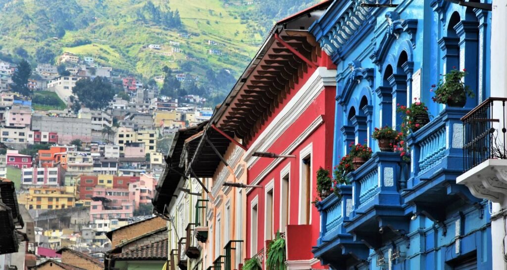 View of beautiful and colorful colonial architecture in Quito, Ecuador with mountains in the background 