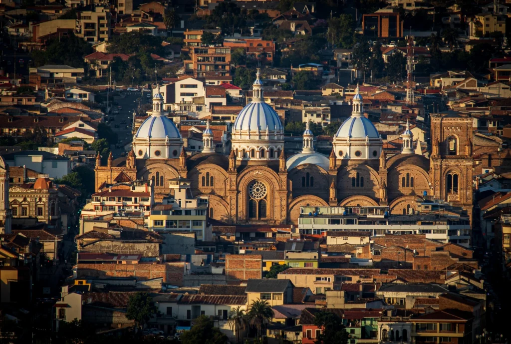An aerial shout of the New Cathedral of Cuenca, Ecuador, showing its blue and white domes. Wheely Tyred Best Alausí Multi-Day Tours