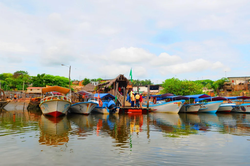 Multicoloured fishing boats float on the water near Guayaquil, Ecuador
