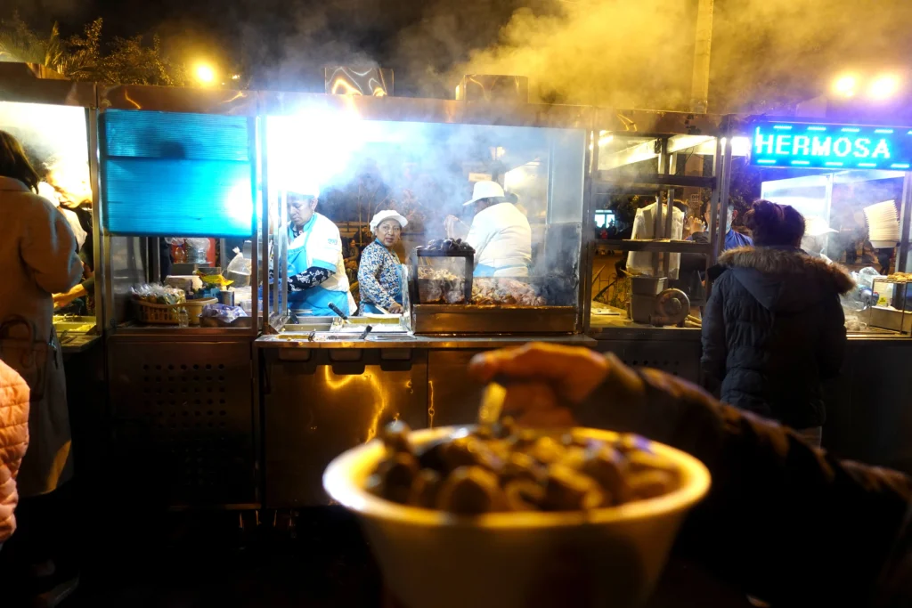 Vendors sell street food in La Floresta, Quito, Ecuador