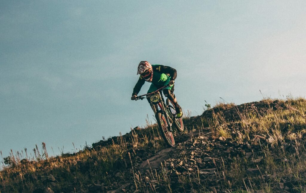 A mountain biker crests a hill in the air on Chimborazo, Ecuador