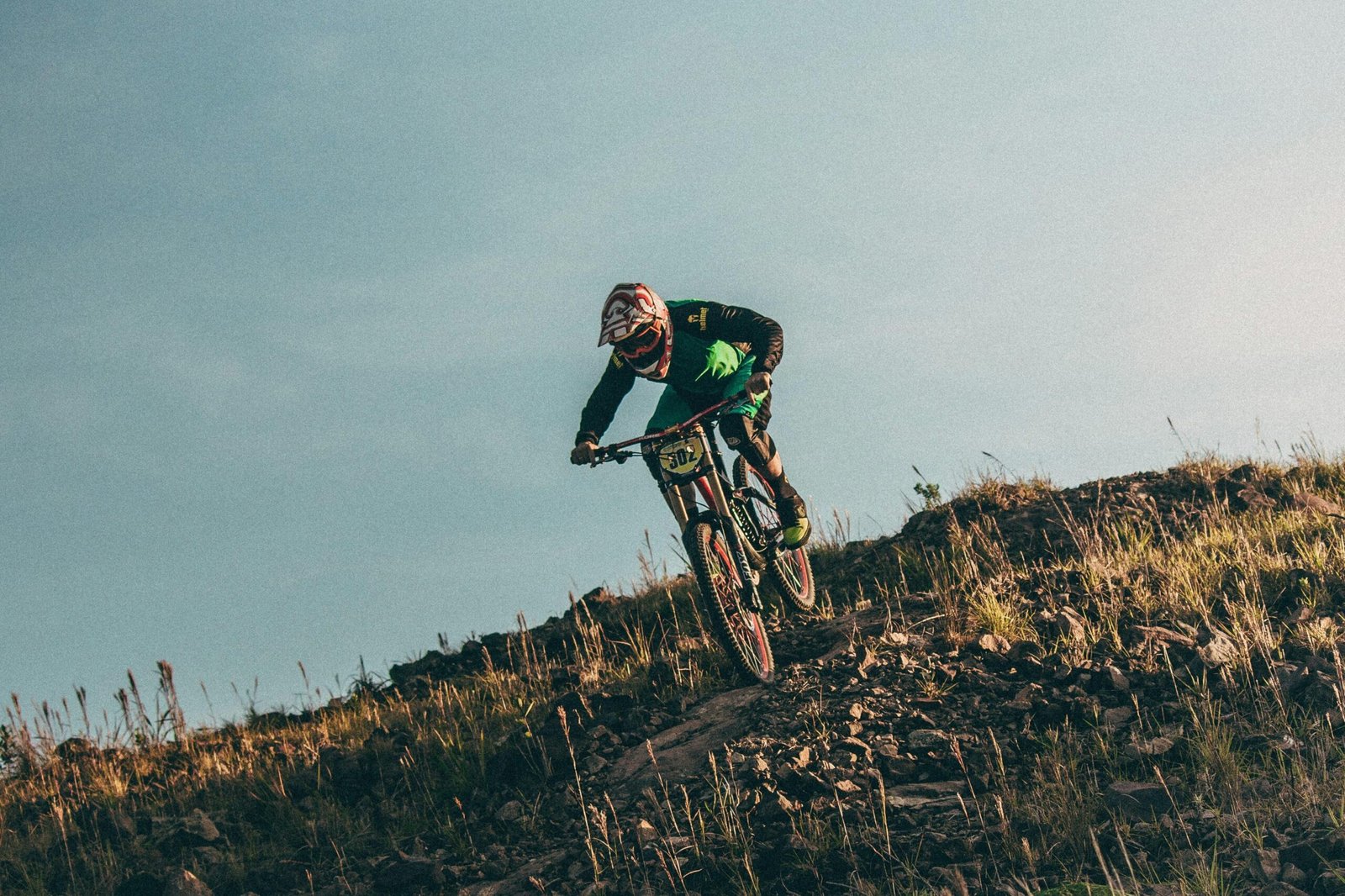 A mountain biker crests a hill in the air on Chimborazo, Ecuador