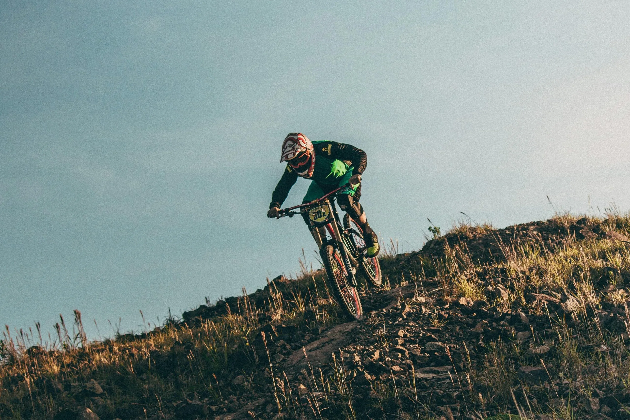 A mountain biker crests a hill in the air on Chimborazo, Ecuador
