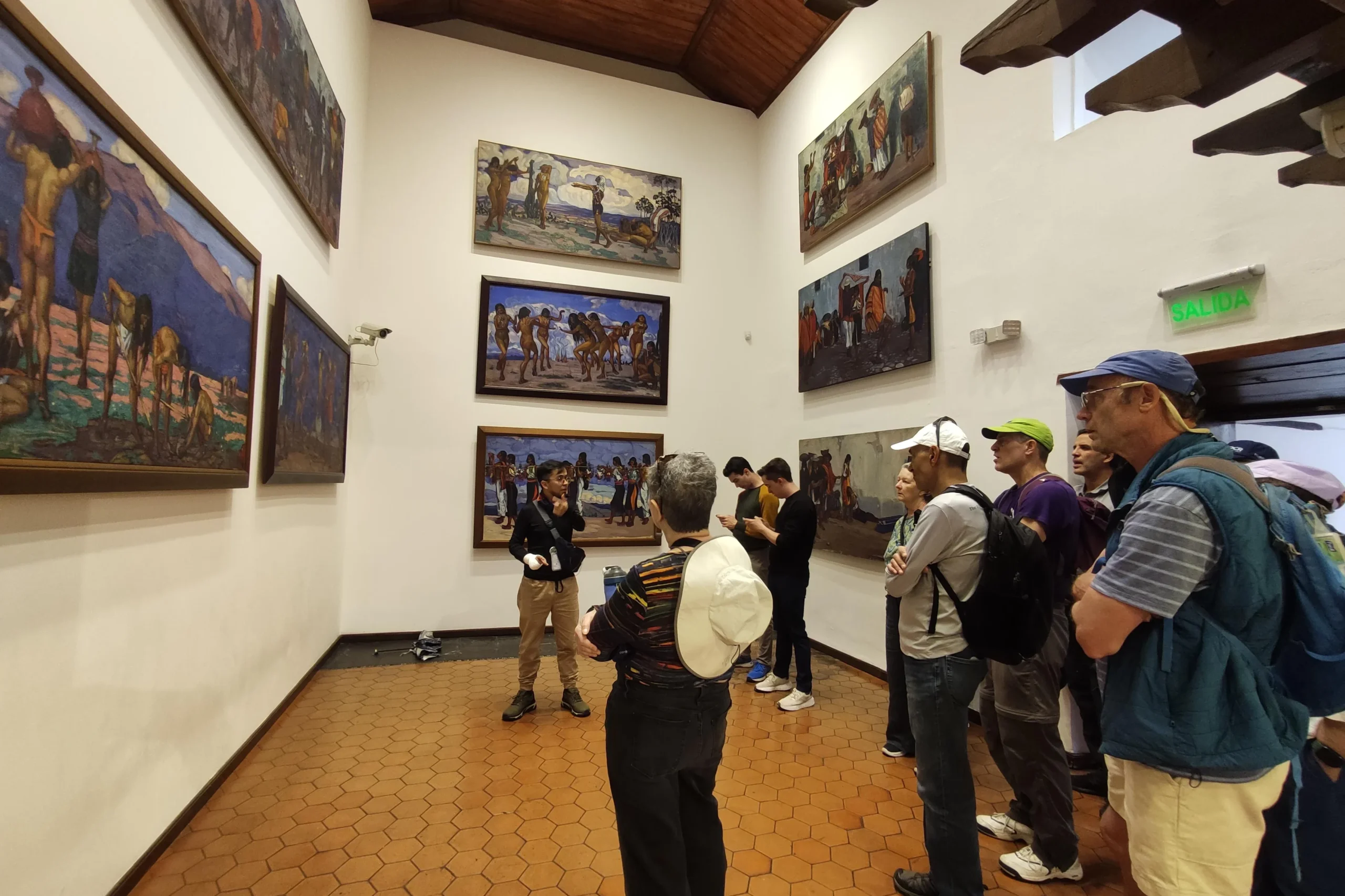 A tour guide shows a group some pictures in a gallery in Quito, Ecuador
