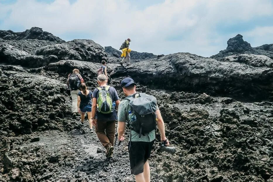 A group hike across basalt to the caldera of rhe Sierra Negra on Isla Isabela, Galápagos