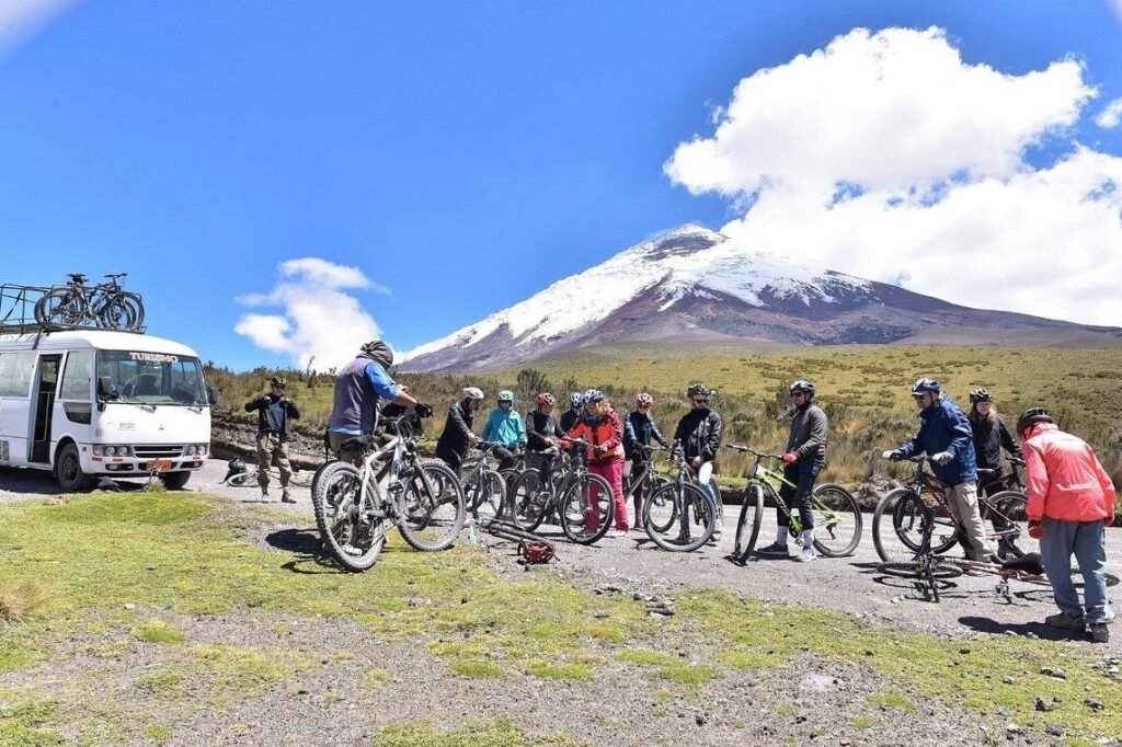 A large group of people on bikes under Cotopaxi, Ecuador