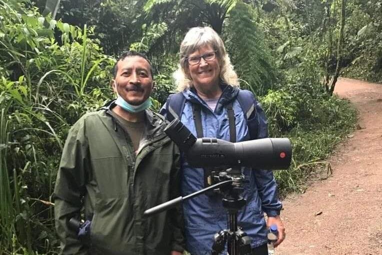A man and woman stand with a telescope in Mindo, Ecuador