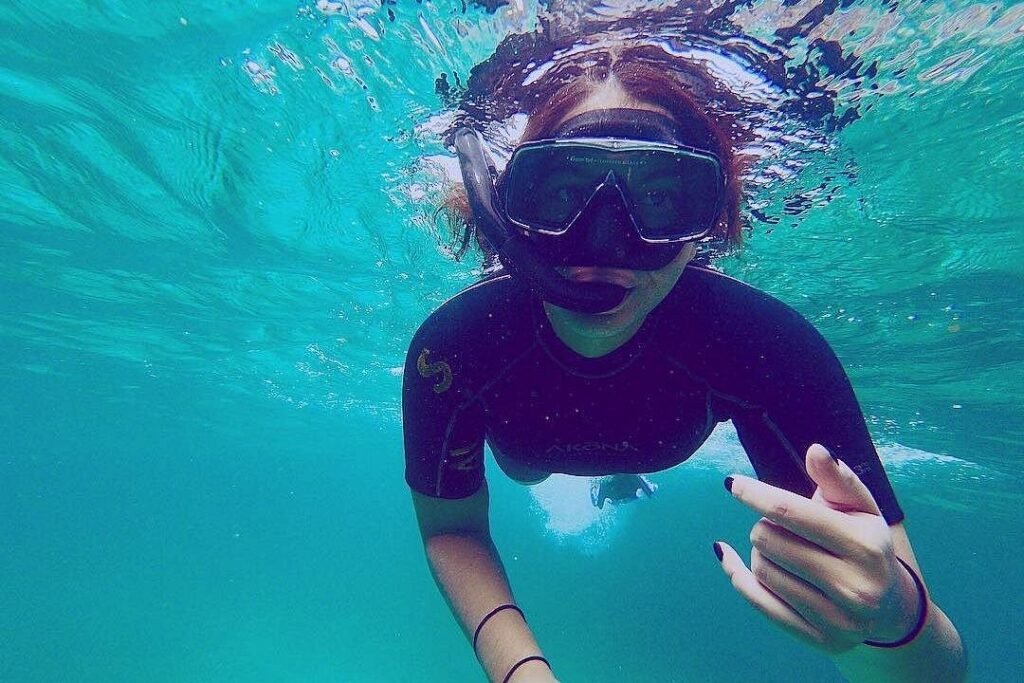 A snorkeller in deep, bright blue water off Pinzón Island, Galápagos