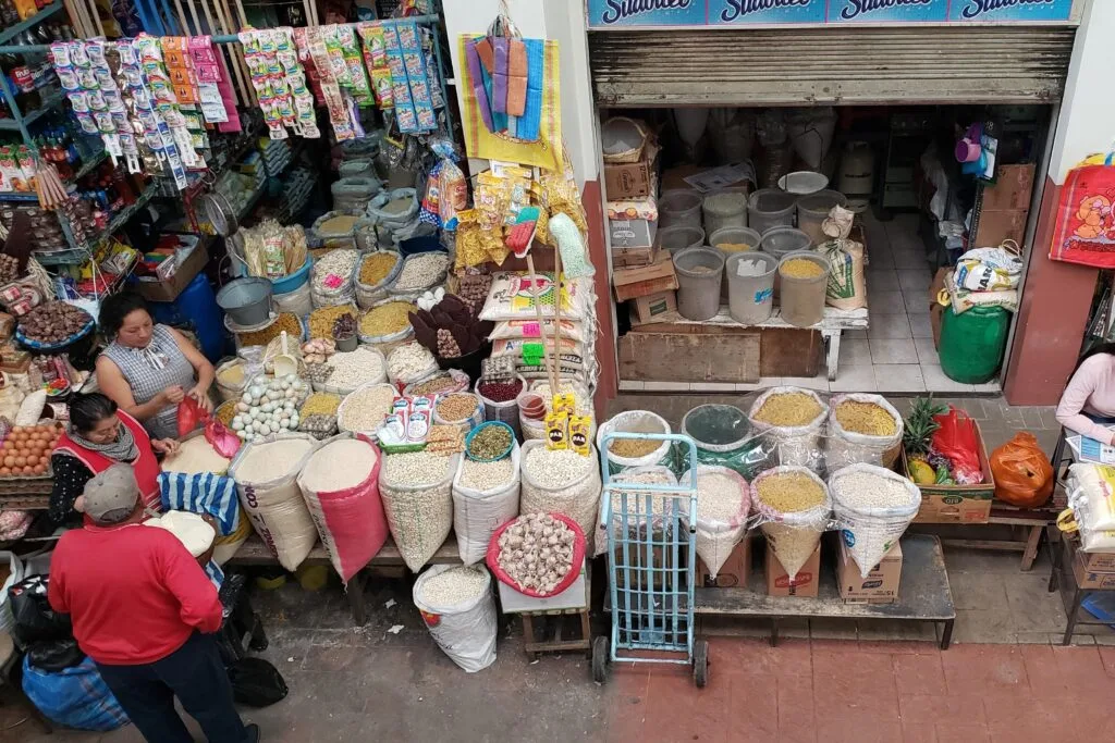 A shot looking down on a large market stall selling herbs, spices and grains in Cuenca, Ecuador