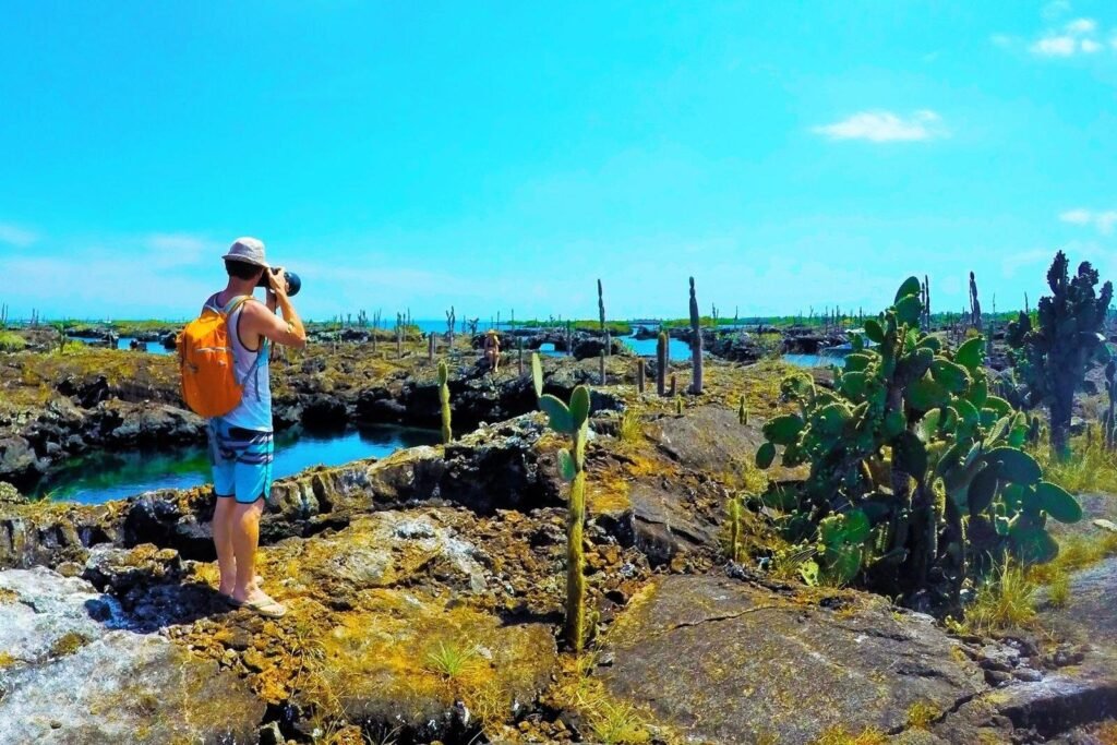 A man takes a picture with a DSLR at Los Tuneles, Isla Isabela, Galápagos Islands