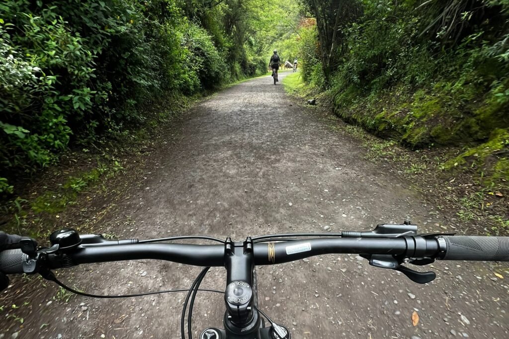 The handlebars of a mountain bike on a trail near Quito, Ecuador