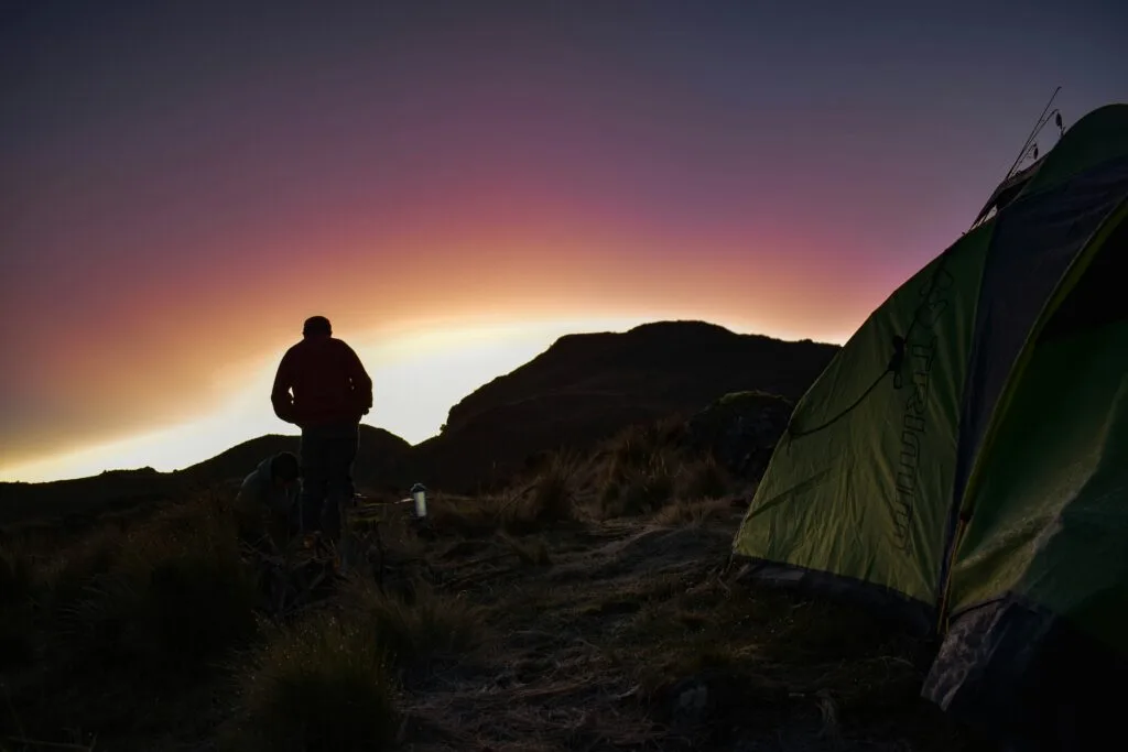 A camper and a tent at sunset in Cajas National Park, near Cuenca, Ecuador