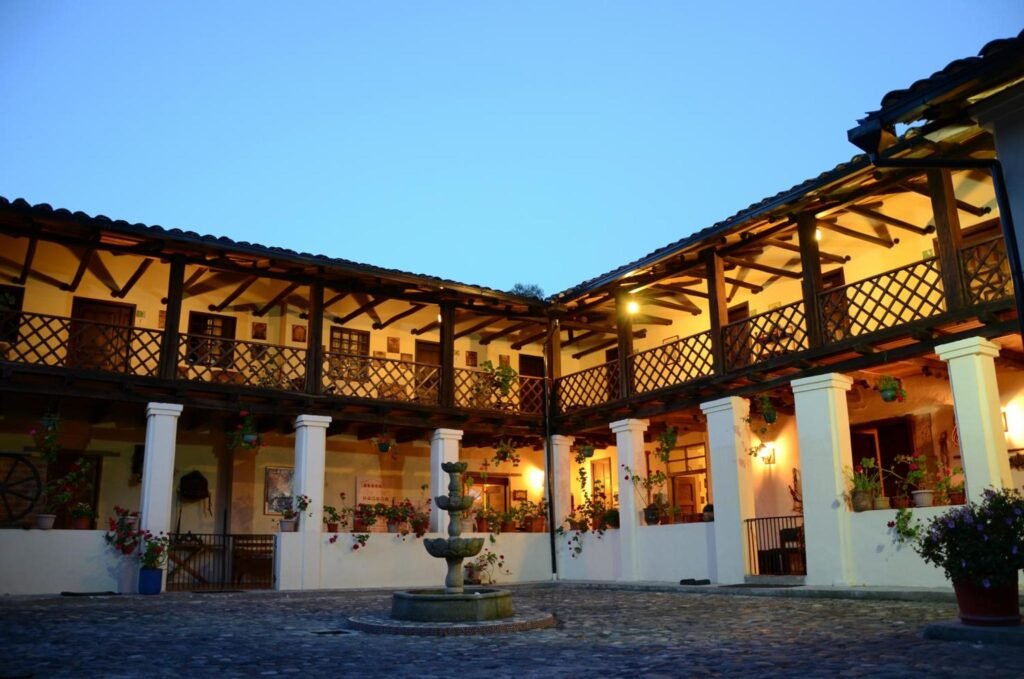 The Spanish colonial Hacienda San Isidro is lit up at dusk in Cotocachi, Ecuador