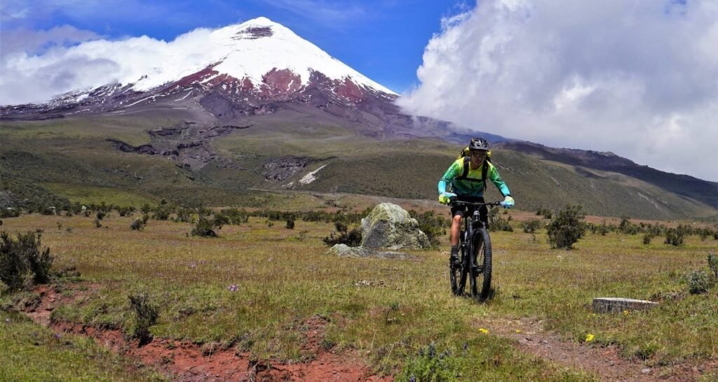 A man rides a mountain bike down the side of Cotopaxi, Ecuador. Wheely Tyred Best Chimborazo multi-day tours
