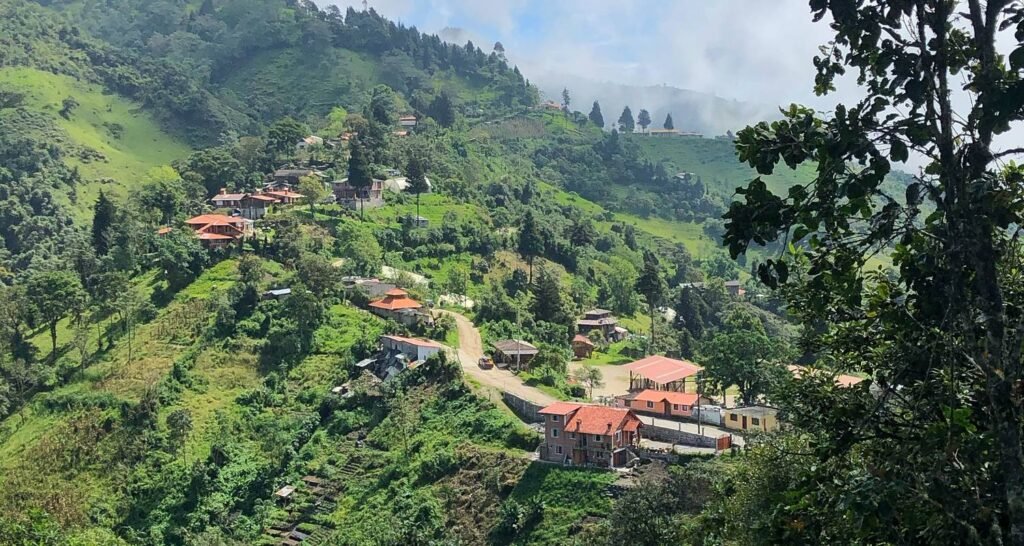 A road runs along a ridge with steep drops on either side in the Andes near Loja, Ecuador