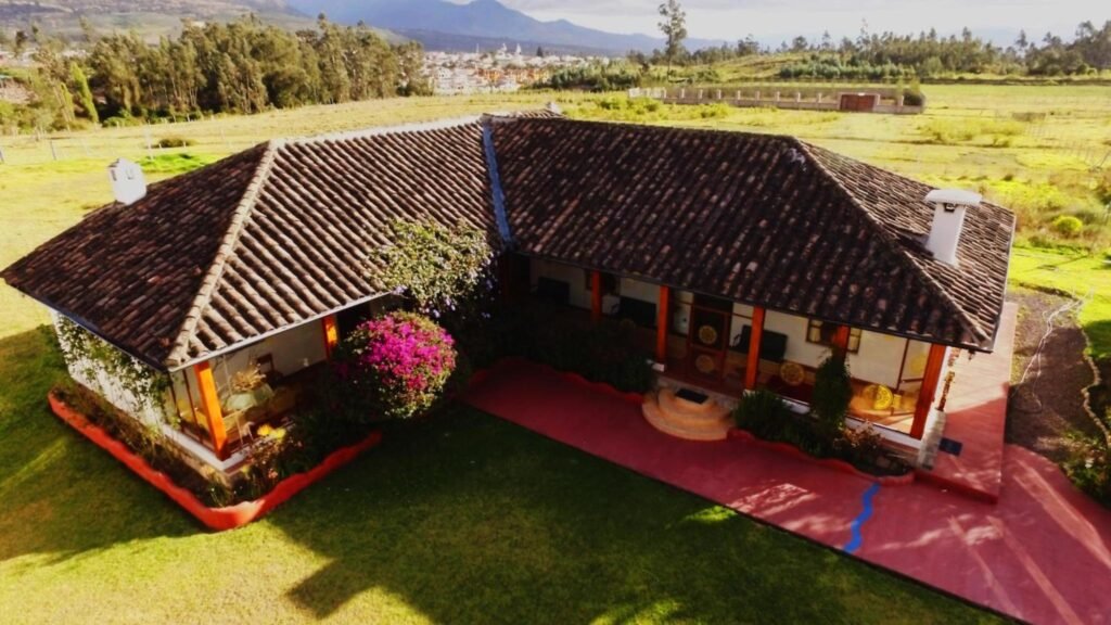 The cottage of Hosteria Oro Azul sits in fields near Cotocachi, Ecuador