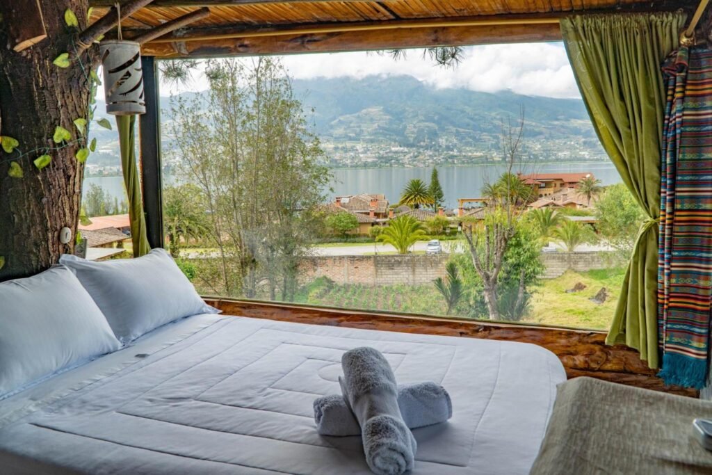 A bedroom with a huge lake stretching out behind it near Otavalo and Cotocachi, Ecuador