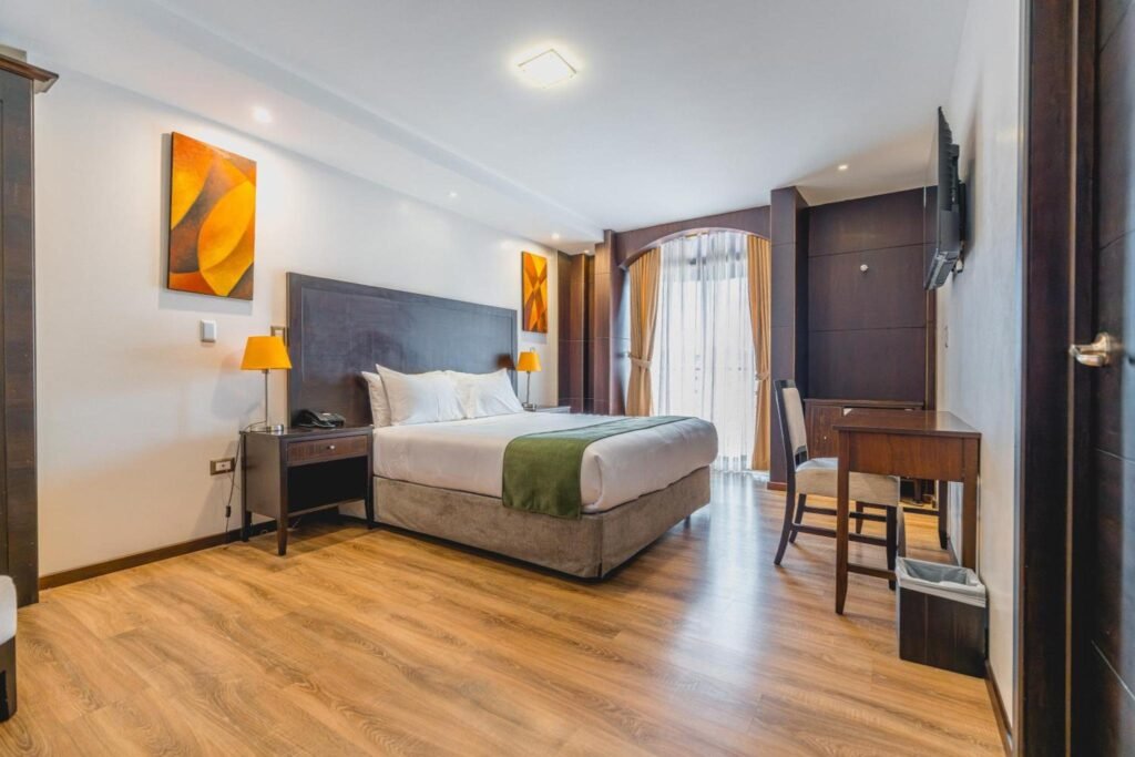A large room at the Zamorano Real Hotel with a double bed in Loja, Ecuador