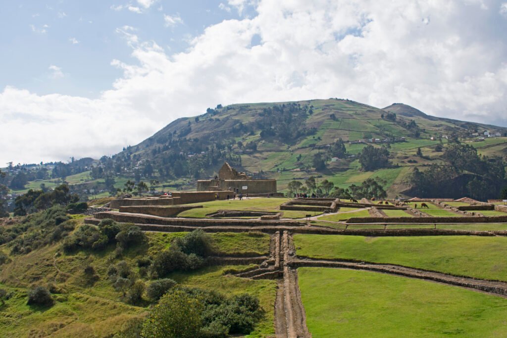 Ruins and the Temple of the Sun at the Ingapirca complex under a blue sky in Ecuador