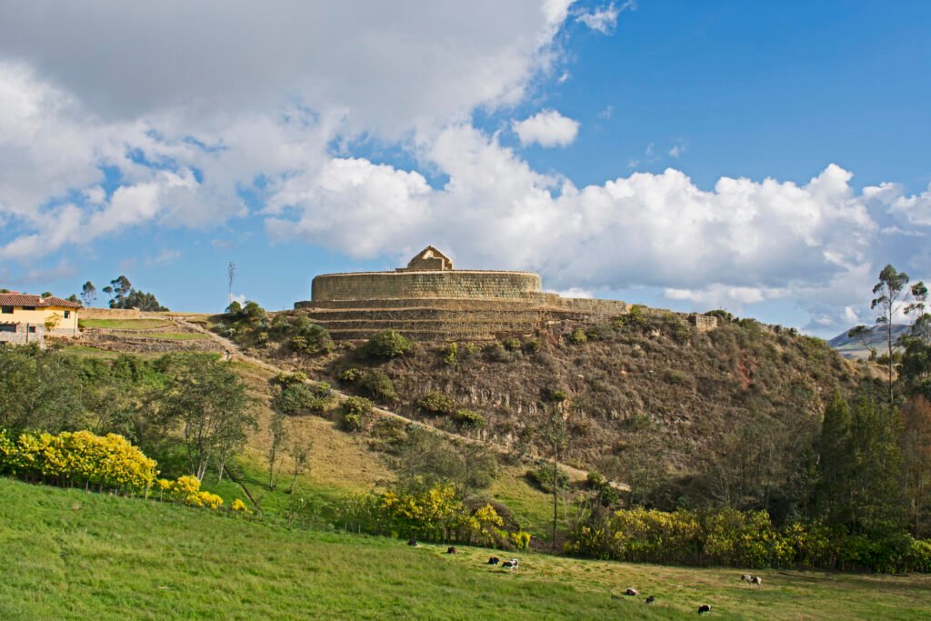 Ruins and the Temple of the Sun at the Ingapirca complex under a blue sky in Ecuador