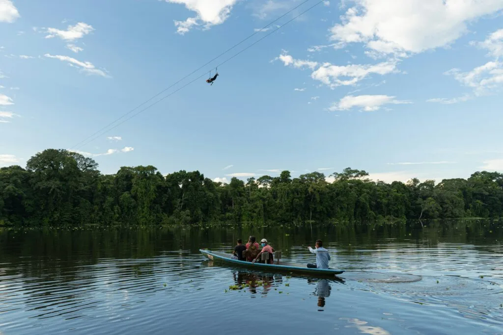 A small motorised canoe on a river in the Amazon, Ecuador