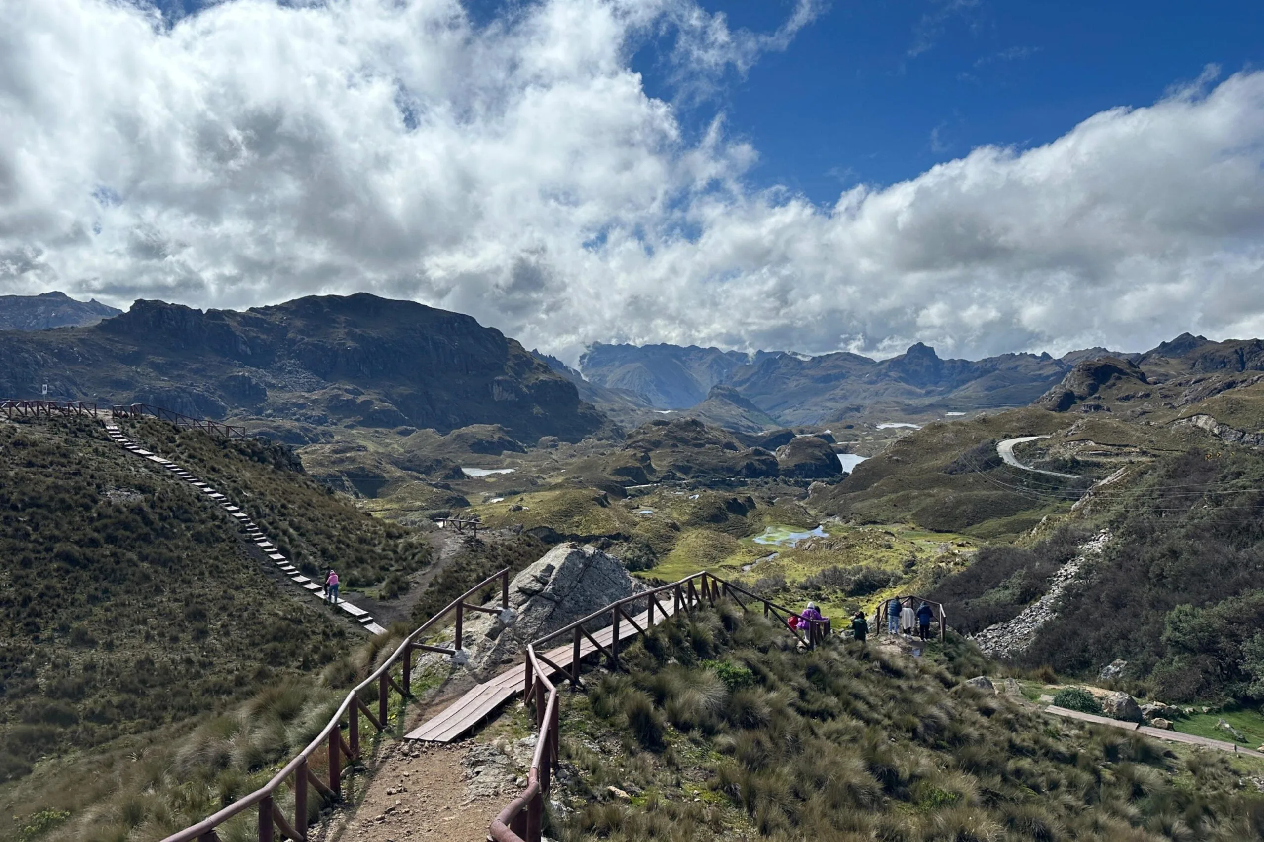 Wooden boartds mark trails that run through the paramo on a sunny day in Cajas National Park, Cuenca, Ecuador