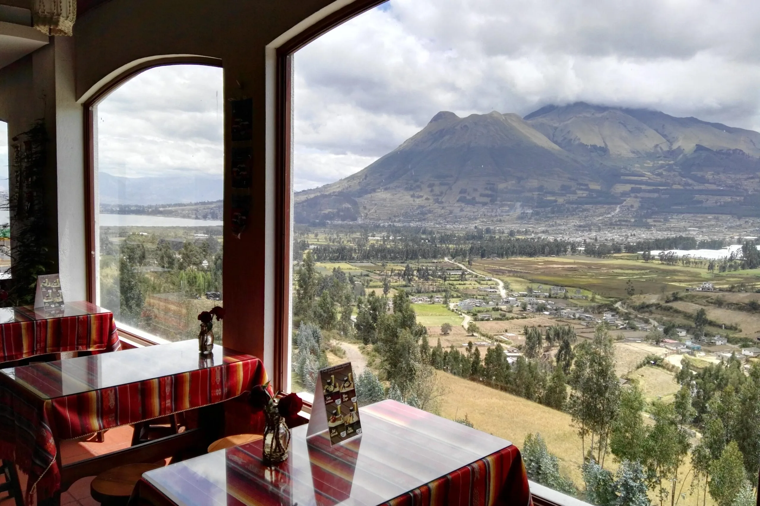Volcan Imbabura and green fields can be seen from a restaurant window near Otavalo, Ecuador