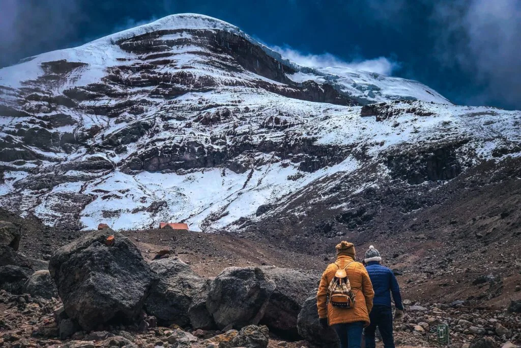 Two people hike towards a refuge on Chimborazo, Ecuador