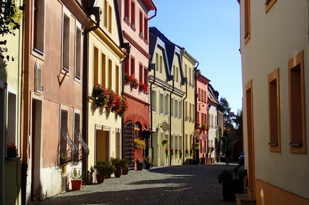 A row of classic Czech buildings and houses along a cobbled street in Olomouc, Czechia