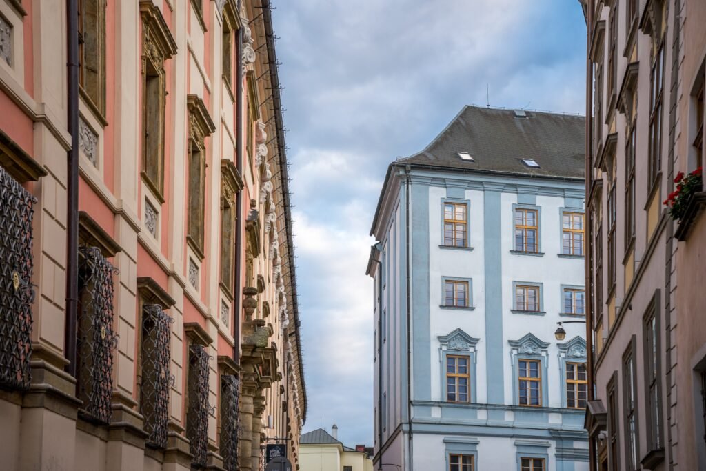 A row of classic Czech buildings and houses along a cobbled street in Olomouc, Czechia